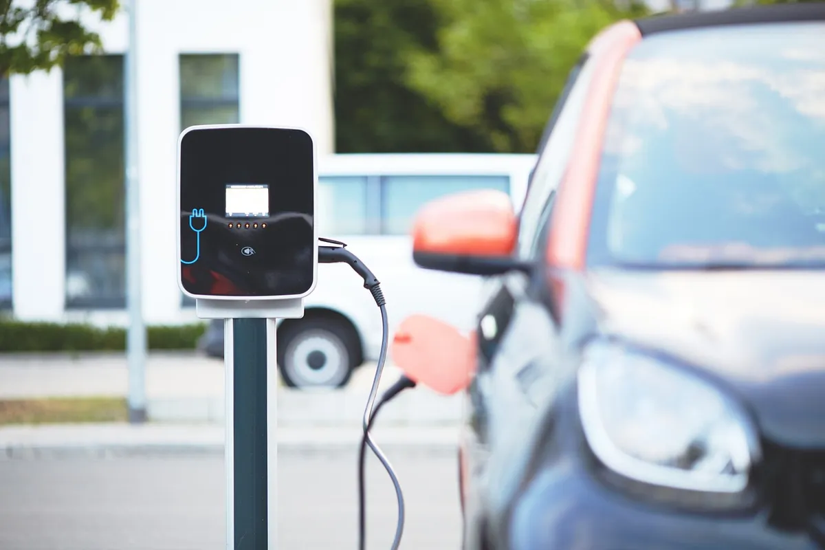 Modern electric vehicle charging at a public charging station with a clean, futuristic design